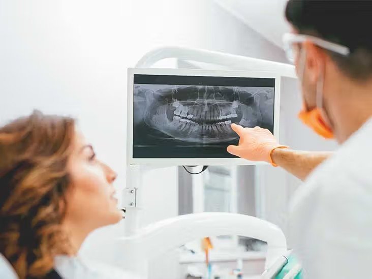 Educational photo illustrating a dental examination with a mouth mirror.